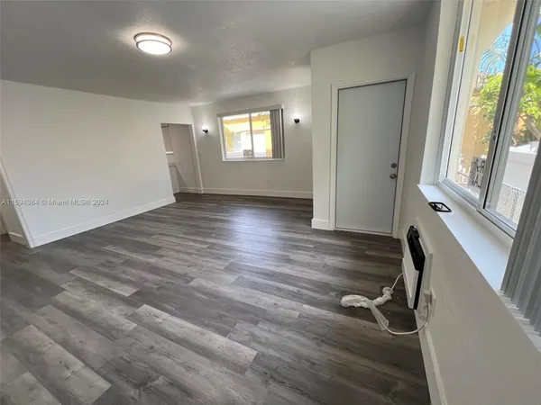 a view of a room with wooden floor and windows