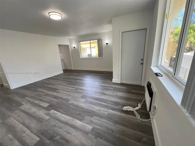 a view of a room with wooden floor and windows