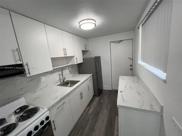 a kitchen with a sink stove and refrigerator