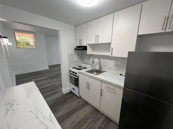 a kitchen with a sink stove and cabinets