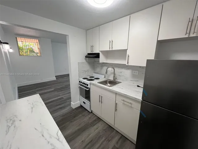 a kitchen with a sink stove and cabinets