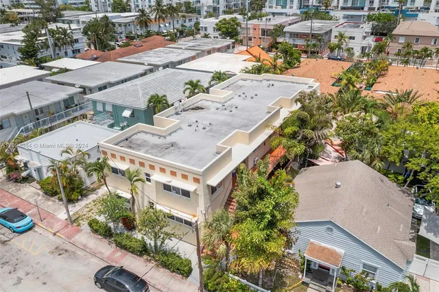 an aerial view of a house with a yard and lake view