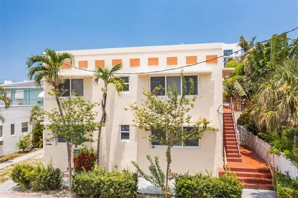 a view of a house with potted plants