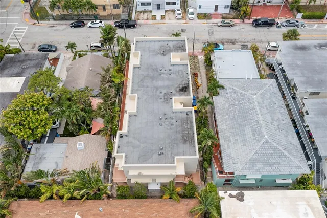 an aerial view of residential houses with outdoor space