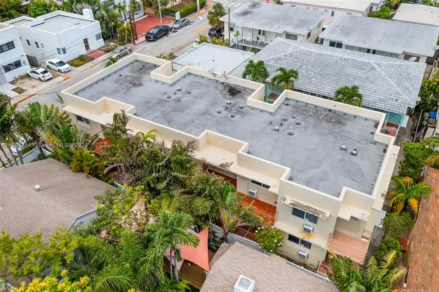 an aerial view of residential houses with outdoor space