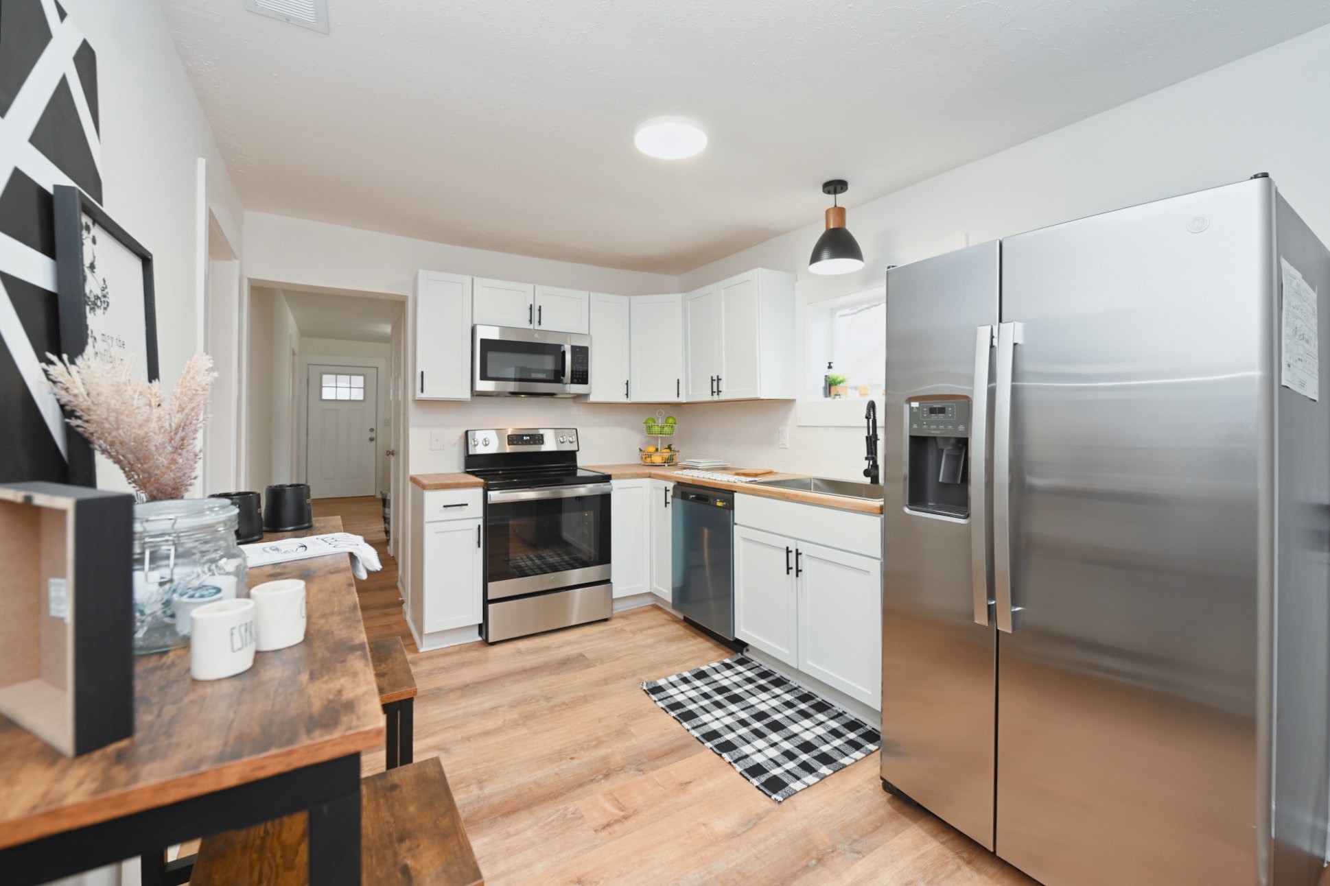 a kitchen with a refrigerator a stove top oven a sink dishwasher and a refrigerator