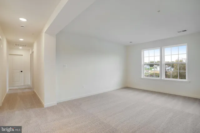 an empty room with a empty space and windows