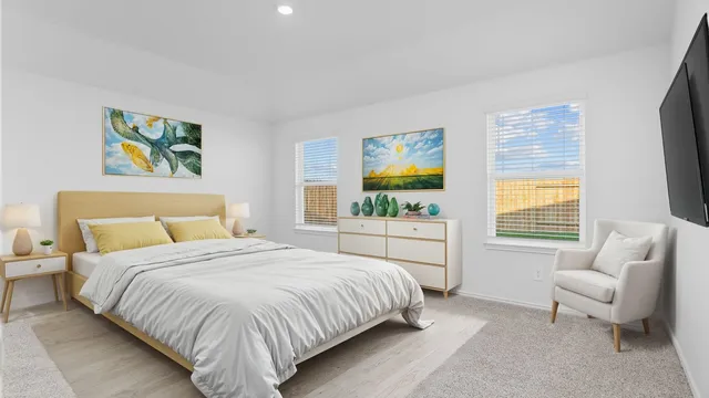 a bedroom with a bed furniture and a flat screen tv