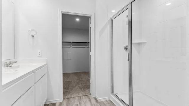 a bathroom with a shower and a sink