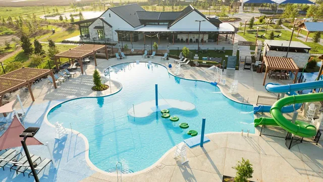 an aerial view of a house outdoor space and swimming pool