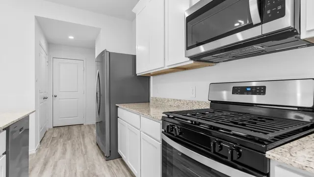 a kitchen with a stove and a microwave