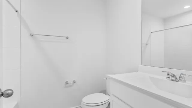 a white toilet sitting next to a bathroom sink