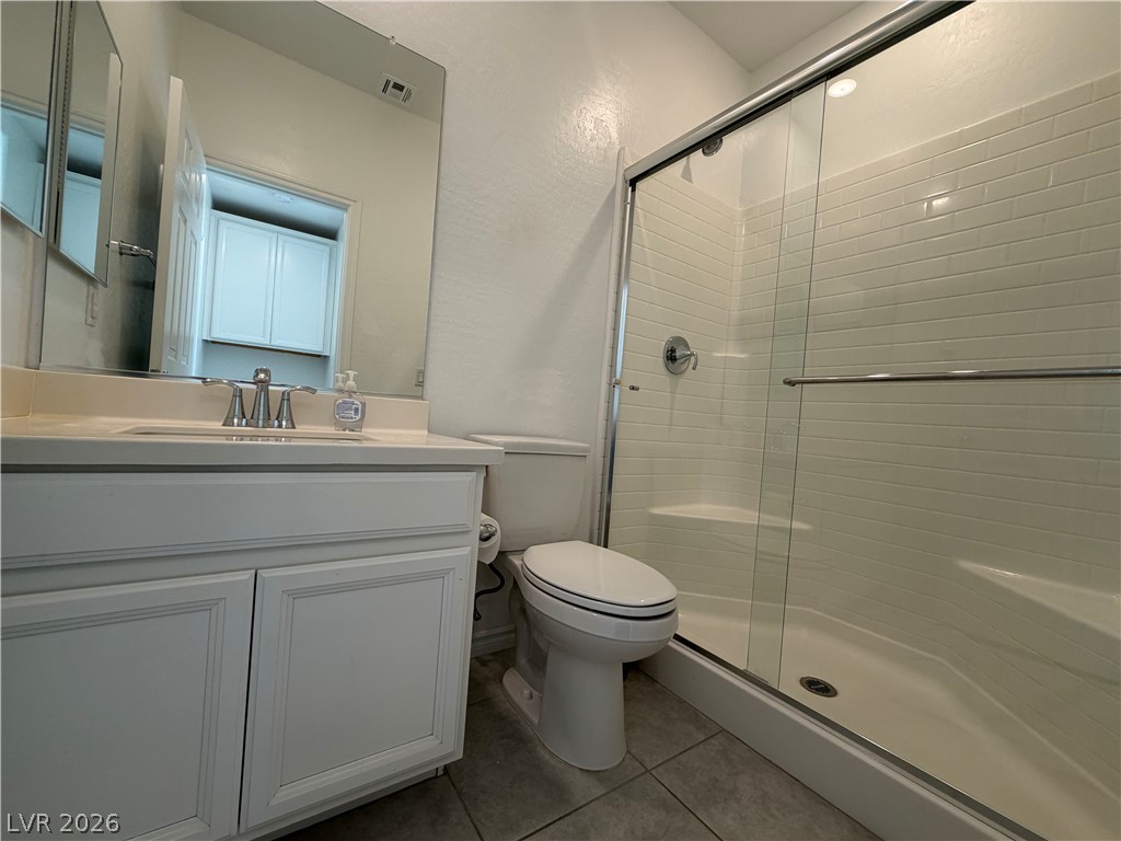 3228 Azalea Ridge Court Henderson, NV 89052 - Photo 22 of 28 A well-appointed bath features a sleek glass-enclosed shower alongside a pristine vanity.