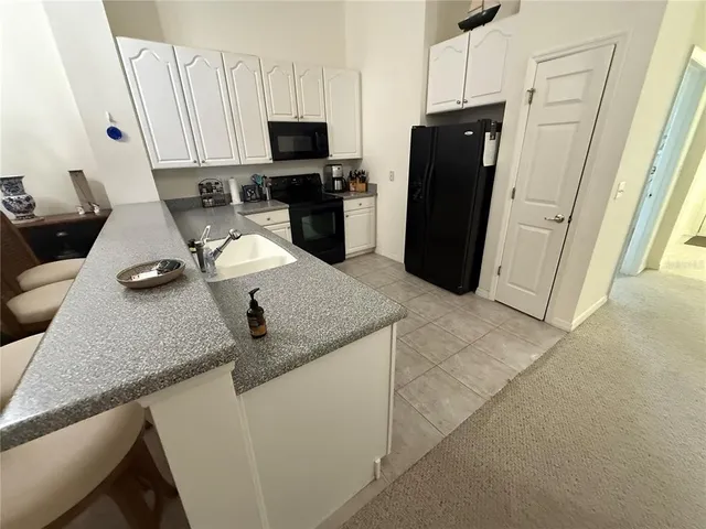 a kitchen with a refrigerator stove and a sink