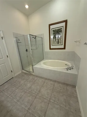 a bathroom with a tub and a shower