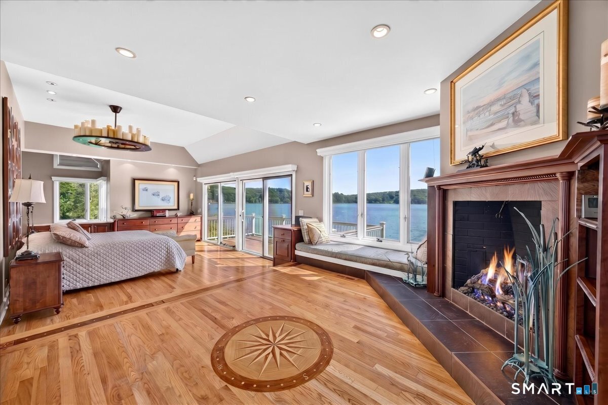 409 River Road Deep River, CT 06417 - Photo 12 of 40 First floor primary bedroom suite with a deck overlooking the beautiful Connecticut River
