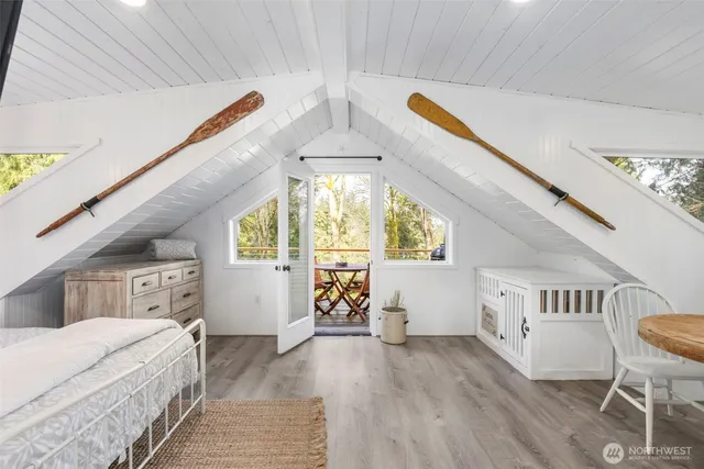 a bedroom with furniture and a large window