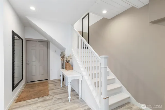 a view of entryway and hall with wooden floor