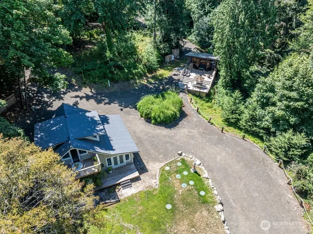 an aerial view of a house with a yard basket ball court and outdoor seating