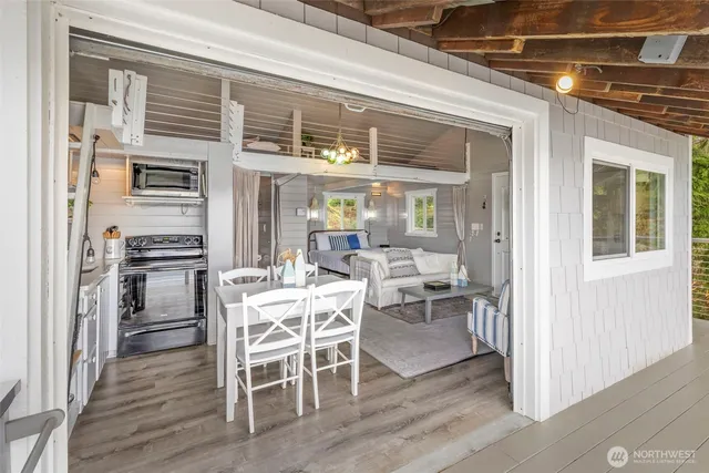 a dining room with furniture and wooden floor