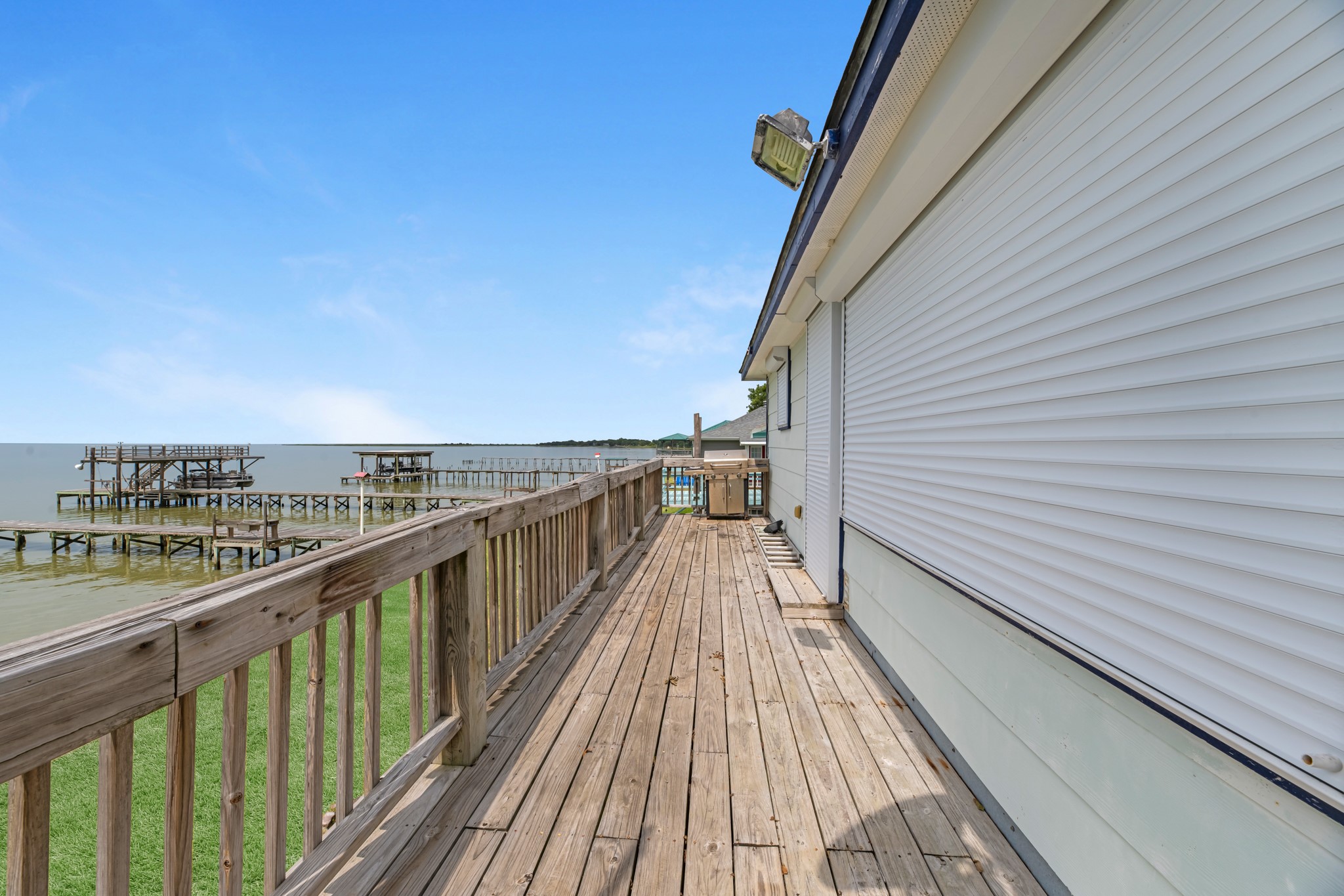 211 Captains Road Anahuac, TX 77514 - Photo 15 of 39 Full-length expansive deck offering front row seating to those bay views!!