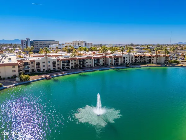 a kitchen with stainless steel appliances granite countertop a refrigerator a sink a stove a counter space and a window