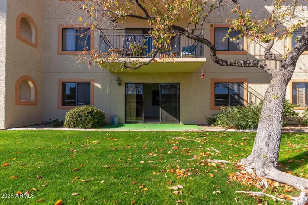 a front view of a building with a garden