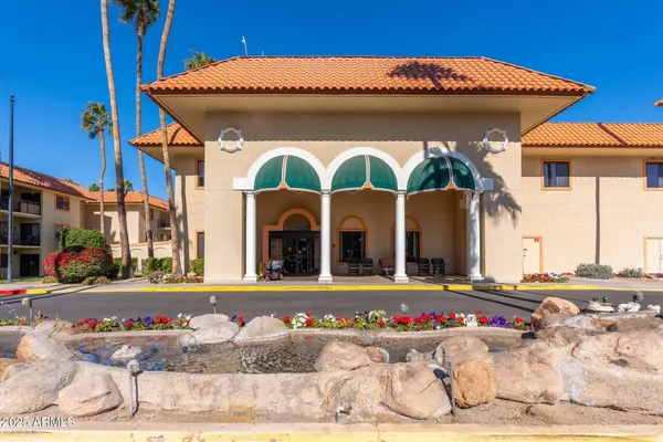 a living room with furniture lots of books and a dining table with bookshelf