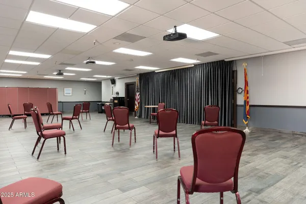 an aerial view of a city with lots of residential buildings ocean and mountain view in back