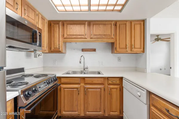 a kitchen with stainless steel appliances granite countertop a refrigerator and a sink