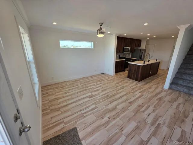 a view of kitchen with kitchen island microwave and stove