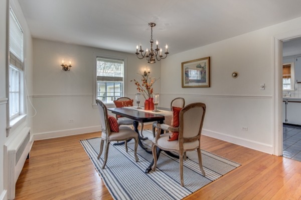 9 Orchard Road Hamilton, MA 01982 - Photo 11 of 22 a dining room with furniture a chandelier and wooden floor