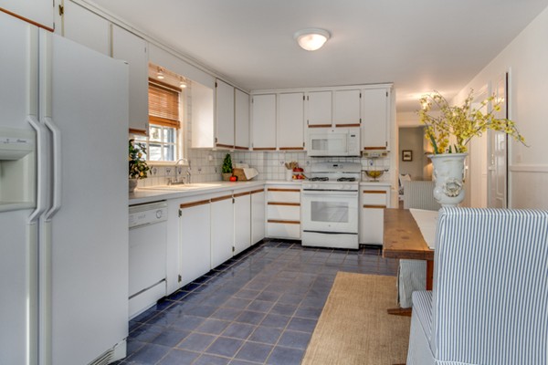 9 Orchard Road Hamilton, MA 01982 - Photo 14 of 22 a kitchen with a sink a window stainless steel appliances and cabinets