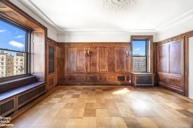 a view of a bedroom with furniture and windows
