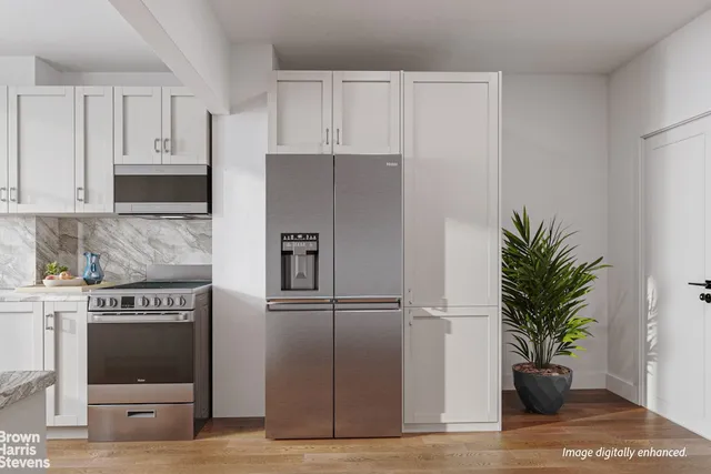 a kitchen with stainless steel appliances a refrigerator a stove a microwave and cabinets