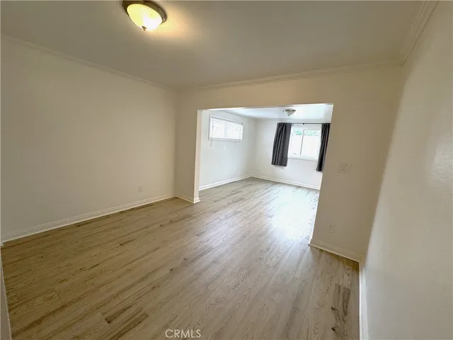 a view of a closet with wooden floor