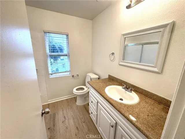 a bathroom with a glass door shower and a sink