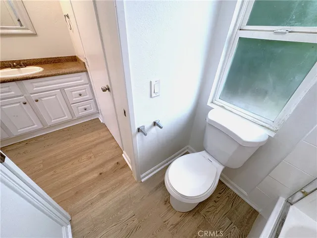 a white toilet sitting next to a shower