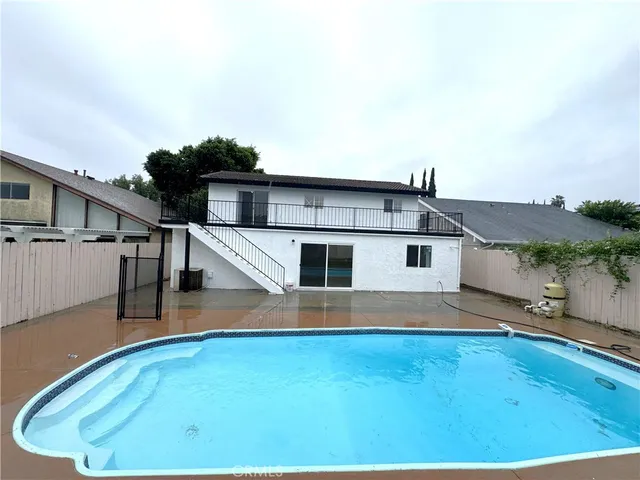 a view of a swimming pool with a yard