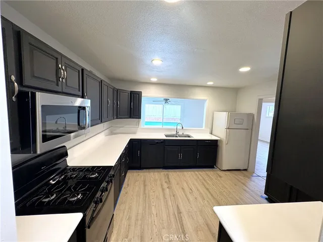 a kitchen with a sink and a stove top oven