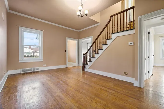 a view of an entryway with wooden floor and stairs