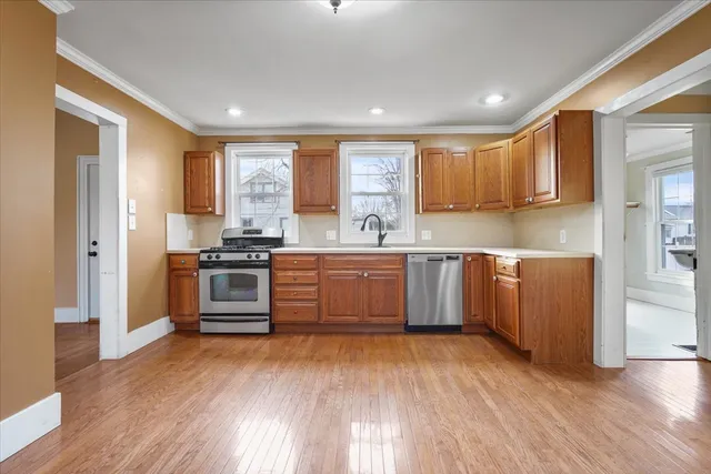 a kitchen with stainless steel appliances a sink and a stove top oven