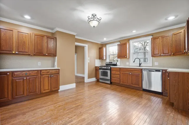 a kitchen with sink a microwave and wooden cabinets