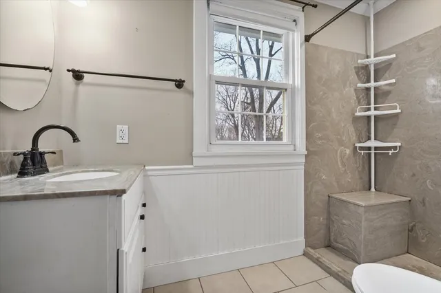 a bathroom with a sink toilet and shower