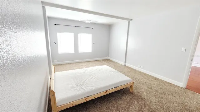 a room with a bed and a window