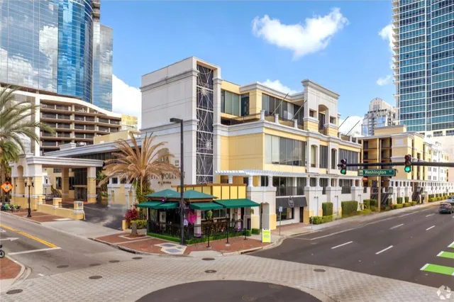 a view of a building with a yard and sitting space