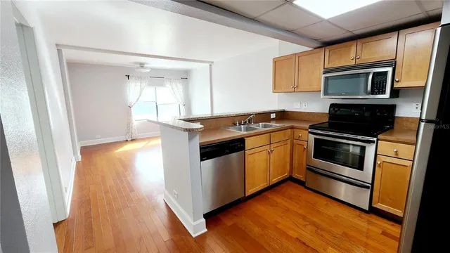 a kitchen with a refrigerator sink and stove