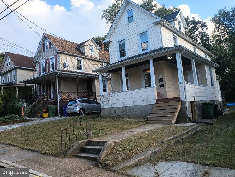 3305 Rosekemp Avenue Baltimore, MD 21214 - Photo 2 of 5 a view of a white house with large windows and a yard