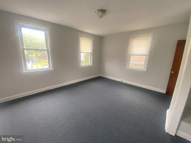 a view of room with window and a fireplace