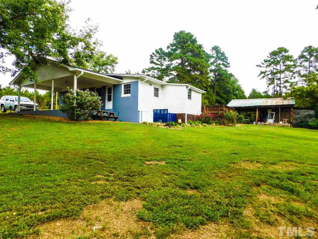 1096 Gillis Road Roxboro, NC 27574 - Photo 2 of 16 a view of a house with a yard and sitting area